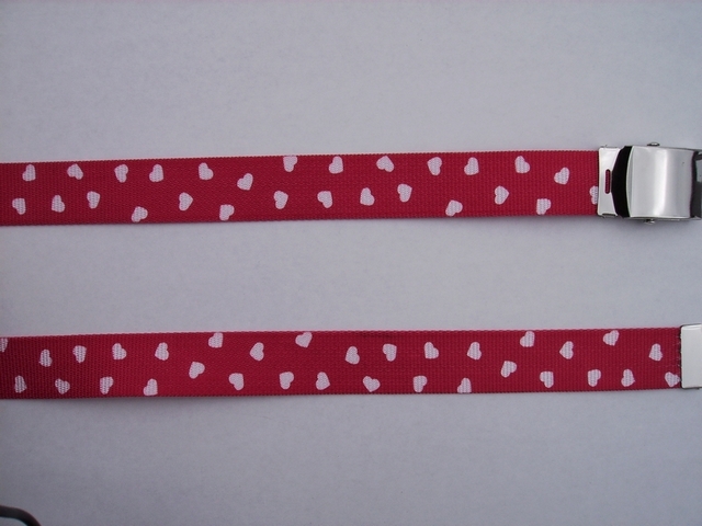 WHITE SMALL HEARTS ON RED - High Quality U.S. Made Cotton/Polyester Non-Stretching Material with Solid Belt Buckle. These will fit all size waists from 8" up to 48" by un-clamping Buckle and cutting off extra material on non-metal end. Then just re-clamp Material. BELT-UA220N48VARE