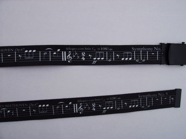 WHITE MUSIC SCORE ON BLACK - High Quality U.S. Made Cotton/Polyester Non-Stretching Material with Solid Belt Buckle. These will fit  all size waists from 8" up to 48"  by un-clamping Buckle and cutting off extra material on non-metal end. Then just re-clamp Material.    BELT-UA220N48MUBK